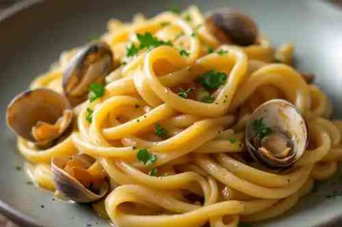 BIGOLI W/CLAMS & LEMON BUTTER recipe served on a plate, by Pekin the Chef